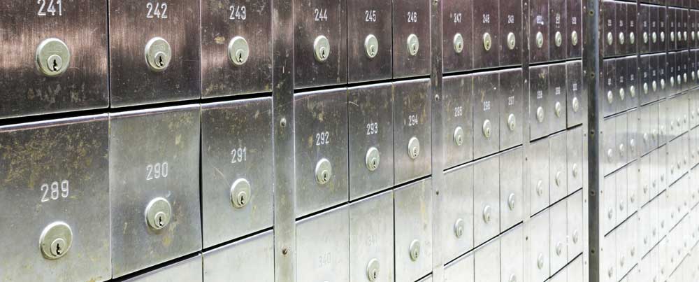 a closeup of a line of lock boxes inside a bank