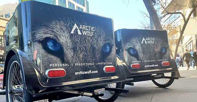 Two Arctic Wolf branded pedicabs outside of RSA 2020