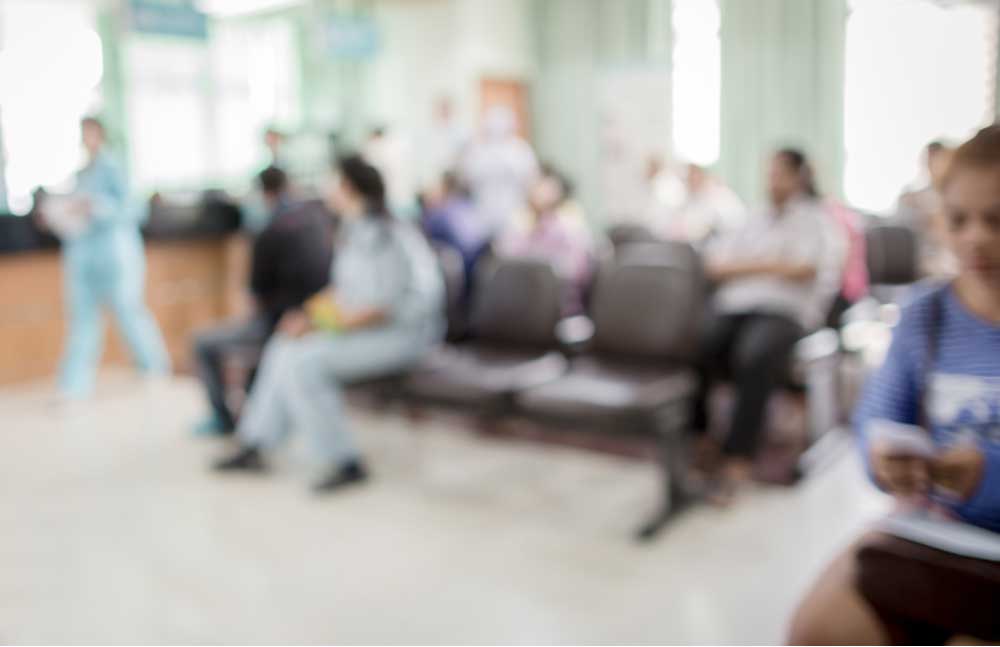 Inside of a hospital waiting room. Out of focus look at people waiting. 