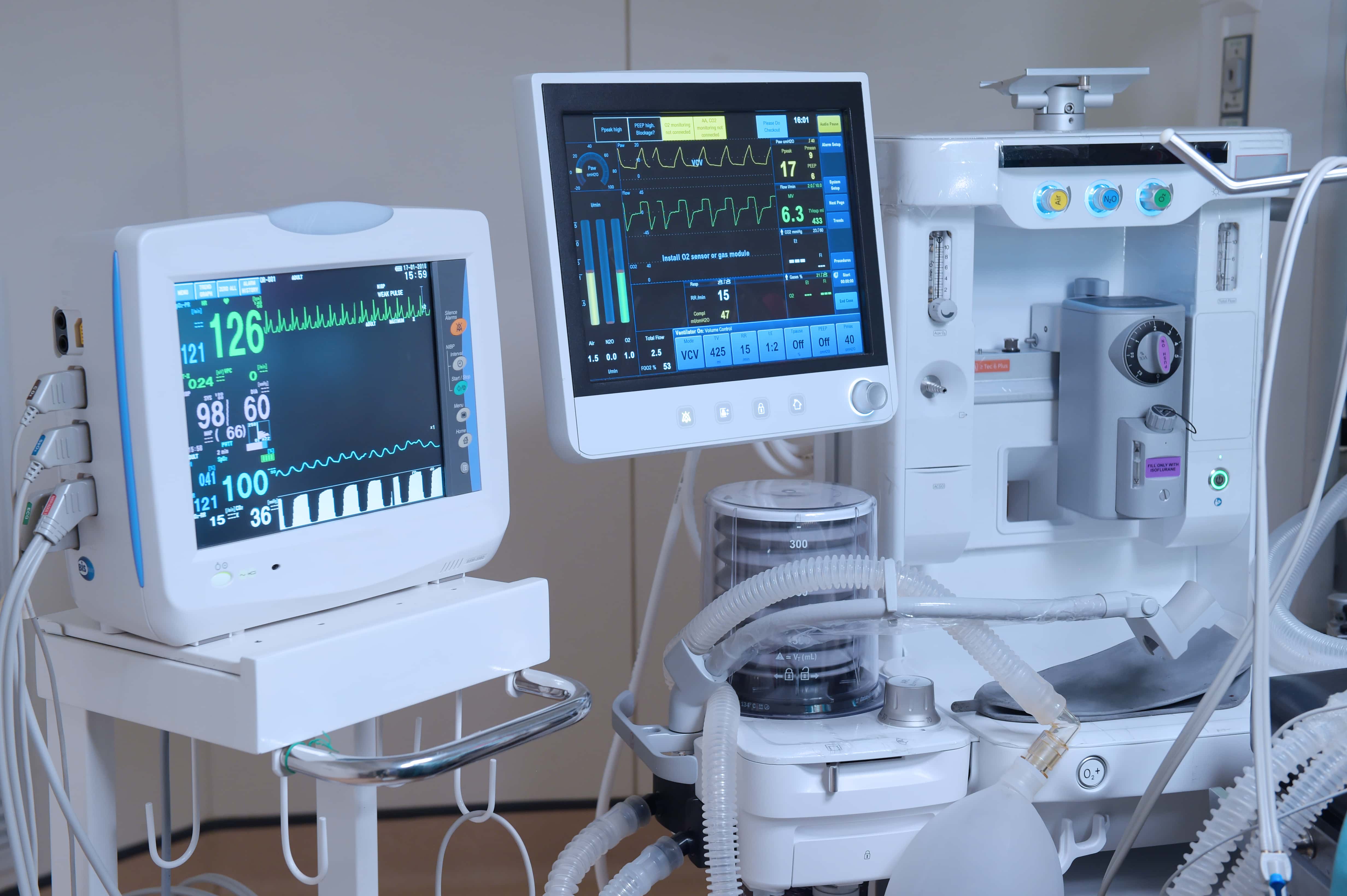 A variety of medical devices inside of a hospital room. 