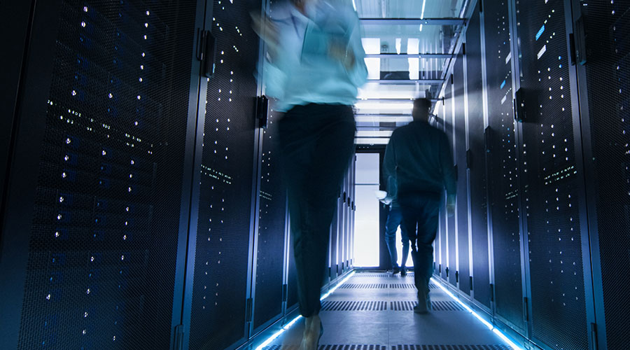 Abstract image of technicians walking through data center