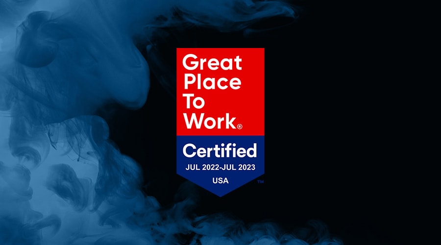 Great Place To Work® Certified July 2022 - July 2023 logo, on a black background with blue smoke