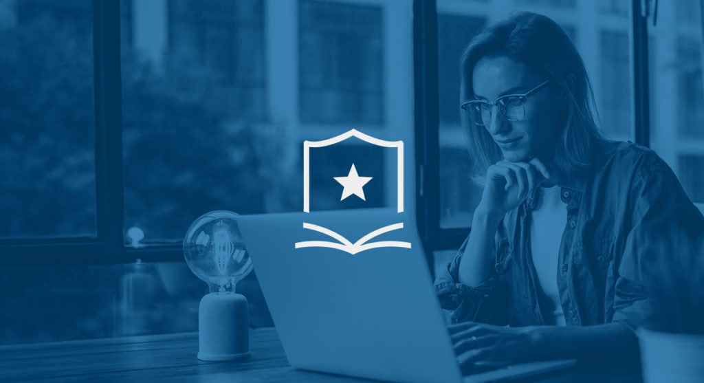 Woman sitting in front of a laptop with a star graphic in the middle of the screen