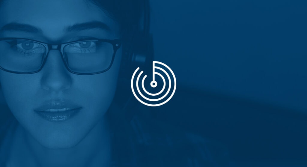Woman with glasses looking at a monitor.