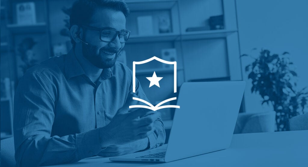 Man with glasses in front of his laptop.
