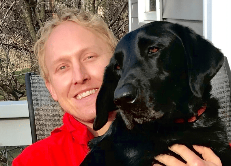 Photo of Andrew Rotschafer and his dog. 